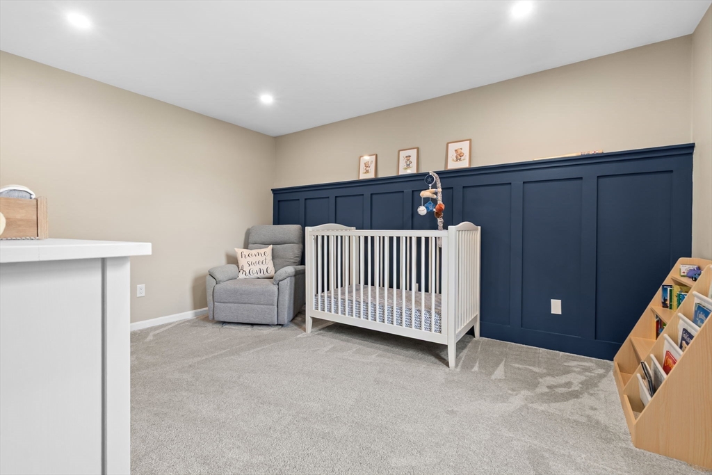 167 Village Post Road, Unit 167 Danvers, MA 01923 - Photo 27 of 42 a bedroom with furniture and window
