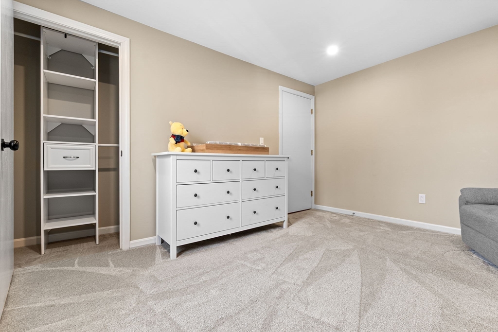 167 Village Post Road, Unit 167 Danvers, MA 01923 - Photo 28 of 42 a view of an empty room with cabinet and stairs