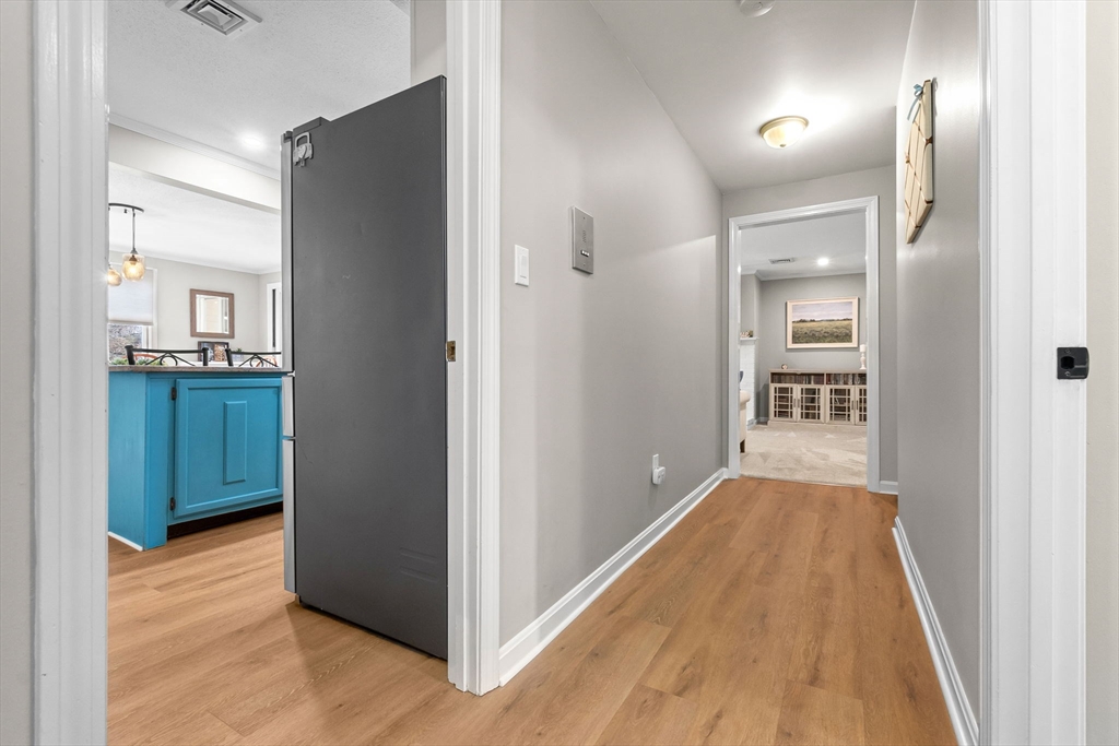 167 Village Post Road, Unit 167 Danvers, MA 01923 - Photo 30 of 42 a view of a hallway with wooden floor