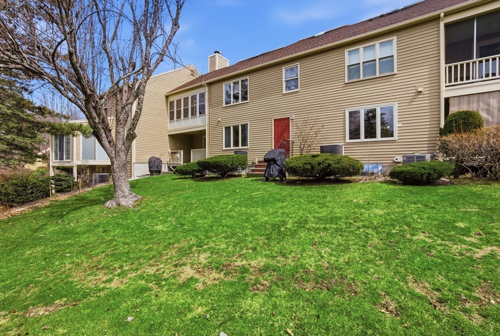 167 Village Post Road, Unit 167 Danvers, MA 01923 - Photo 34 of 42 a front view of a house with a garden
