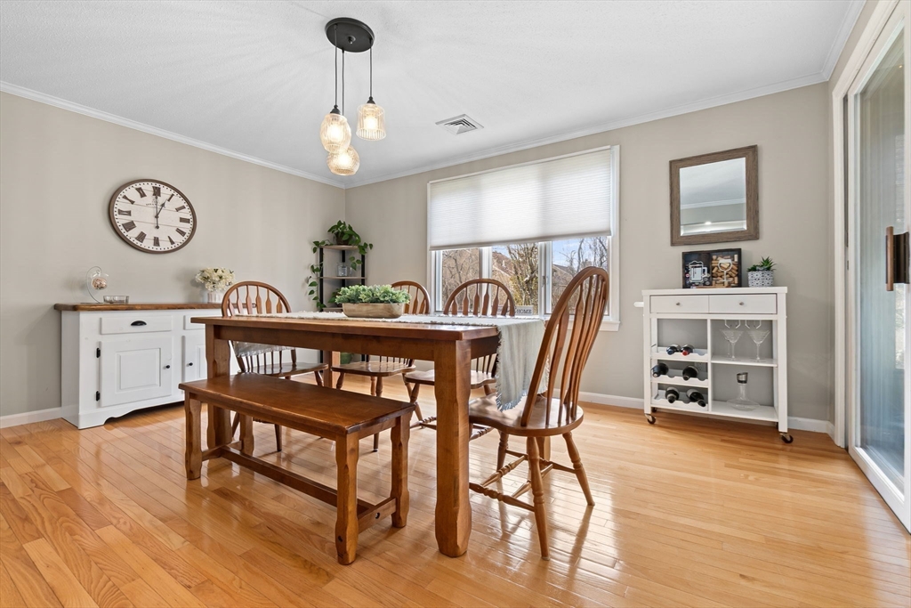 167 Village Post Road, Unit 167 Danvers, MA 01923 - Photo 4 of 42 a dining room with furniture and wooden floor