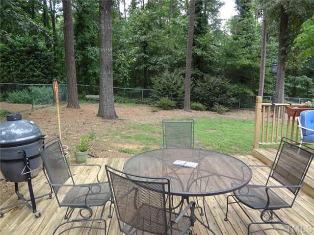 1501 Falls Church Road Raleigh, NC 27609 - Photo 23 of 25 a view of a patio with a table chairs and a backyard