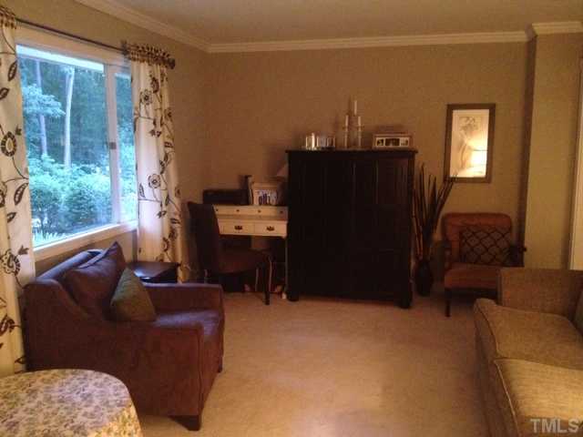1501 Falls Church Road Raleigh, NC 27609 - Photo 5 of 25 a living room with furniture a lamp and a closet