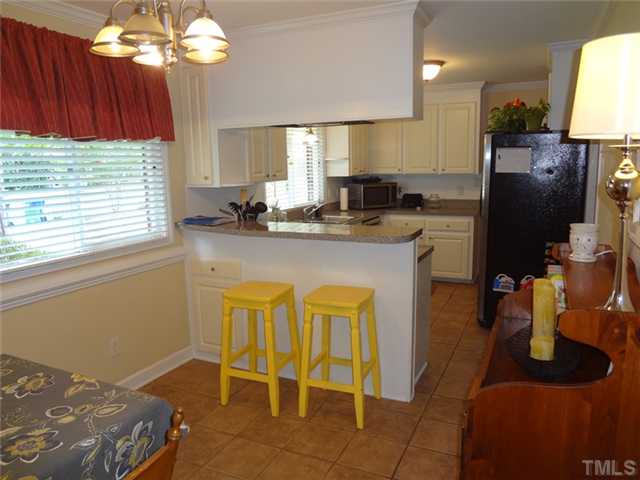 1501 Falls Church Road Raleigh, NC 27609 - Photo 8 of 25 a kitchen with sink cabinets and window