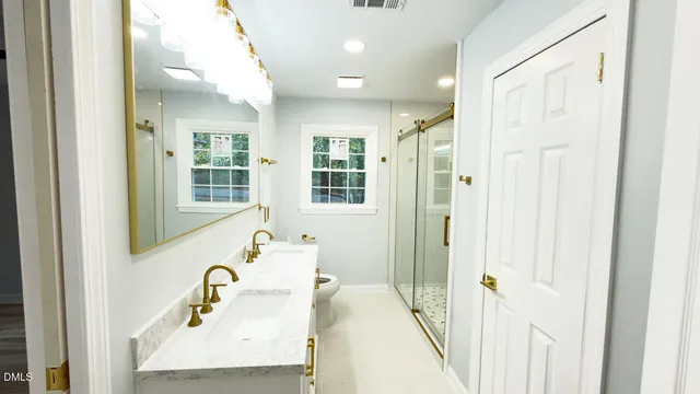 a bathroom with a tub sink and mirror