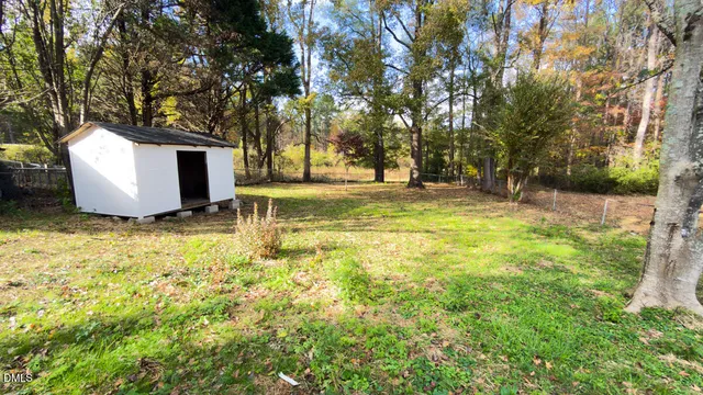 a white house that has a tree in front of it