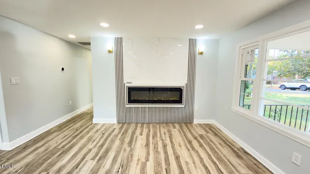 a view of a hallway with wooden floor and a floor to ceiling window