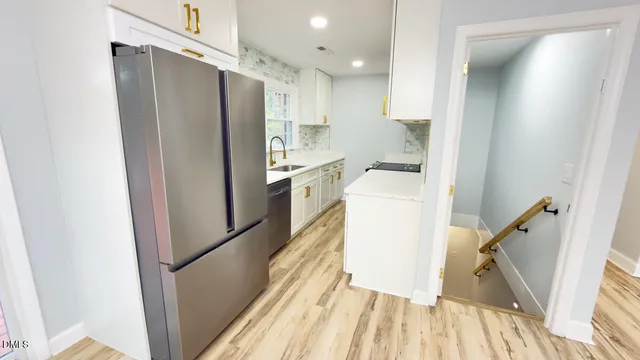 a kitchen with a refrigerator a sink and dishwasher