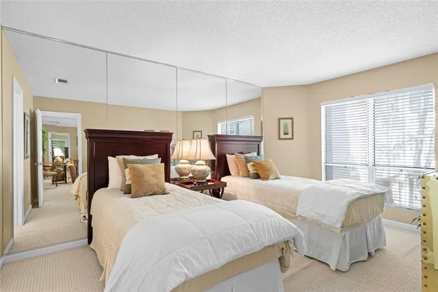 a bedroom with two beds and a large window