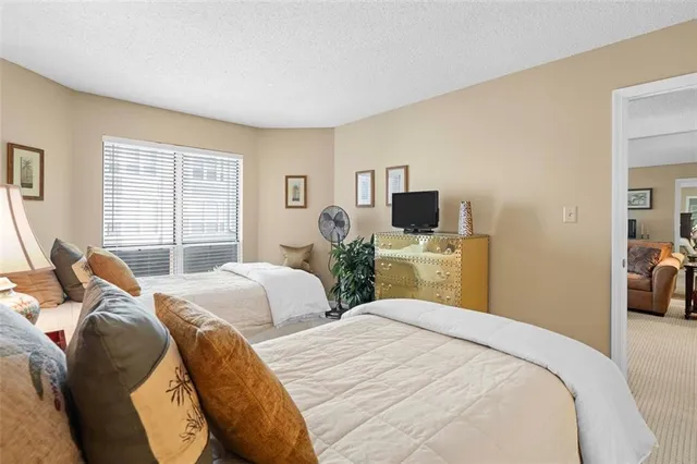 a bedroom with two beds and a tv