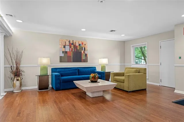 a living room with furniture and a wooden floor