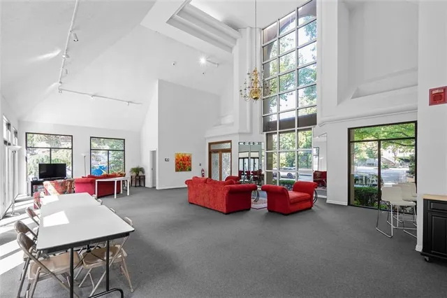 a living room with furniture and large windows