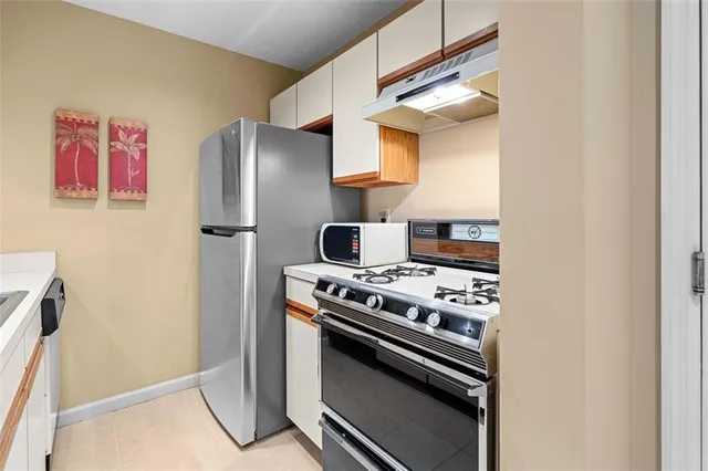 a kitchen with a stove and a refrigerator