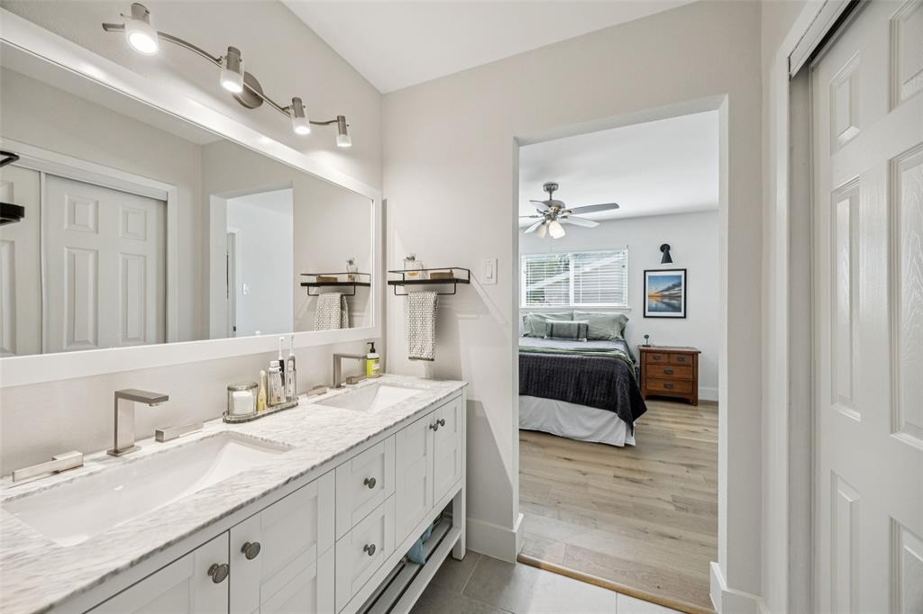 3412 Old Colony Road Dallas, TX 75233 - Photo 17 of 30 a bathroom with a double vanity sink and mirror