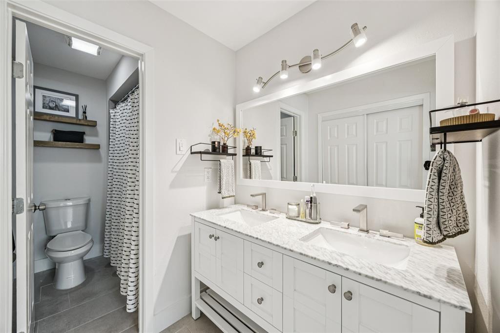 3412 Old Colony Road Dallas, TX 75233 - Photo 18 of 30 a bathroom with a granite countertop sink double vanity and a mirror