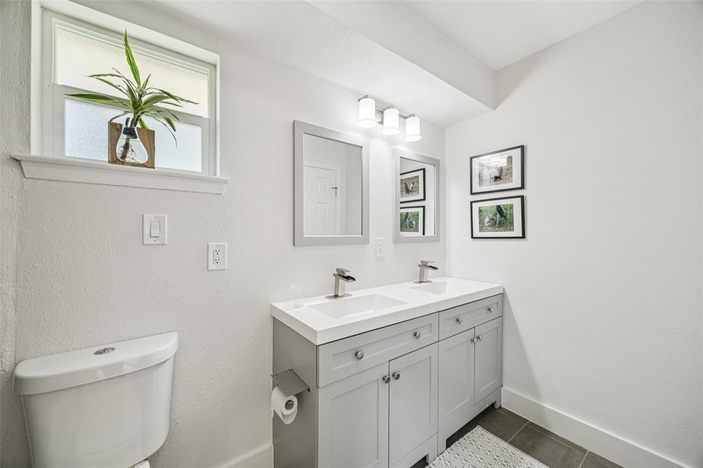 3412 Old Colony Road Dallas, TX 75233 - Photo 23 of 30 a bathroom with a toilet sink and mirror