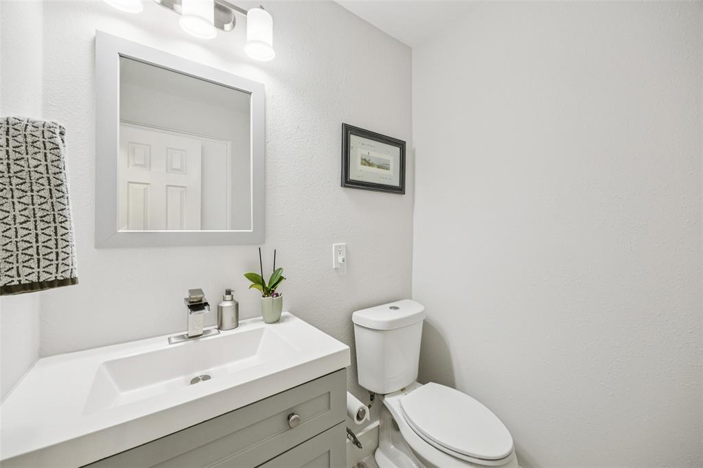 3412 Old Colony Road Dallas, TX 75233 - Photo 26 of 30 a white toilet sitting next to a bathroom sink