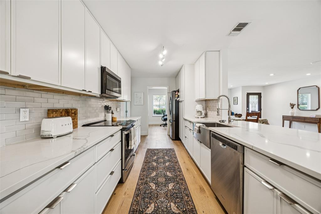 3412 Old Colony Road Dallas, TX 75233 - Photo 10 of 30 a large kitchen with stainless steel appliances granite countertop lots of counter space sink and cabinets
