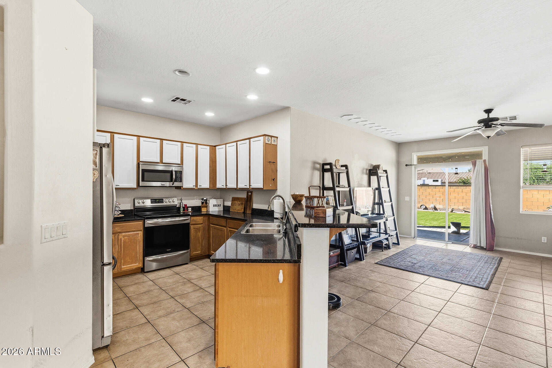 6718 West Darrel Road Laveen, AZ 85339 - Photo 34 of 49 a kitchen with stainless steel appliances granite countertop a refrigerator and a stove top oven