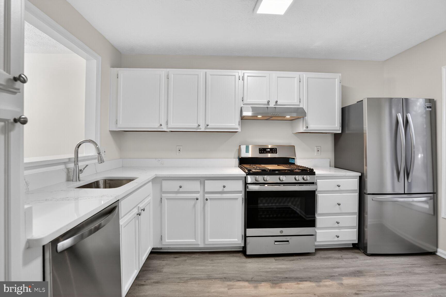 2273 Hunter's Run Drive Reston, VA 20191 - Photo 14 of 23 a kitchen with stainless steel appliances granite countertop a sink stove and refrigerator