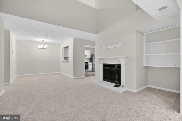 a view of a livingroom with a fireplace cabinet and window