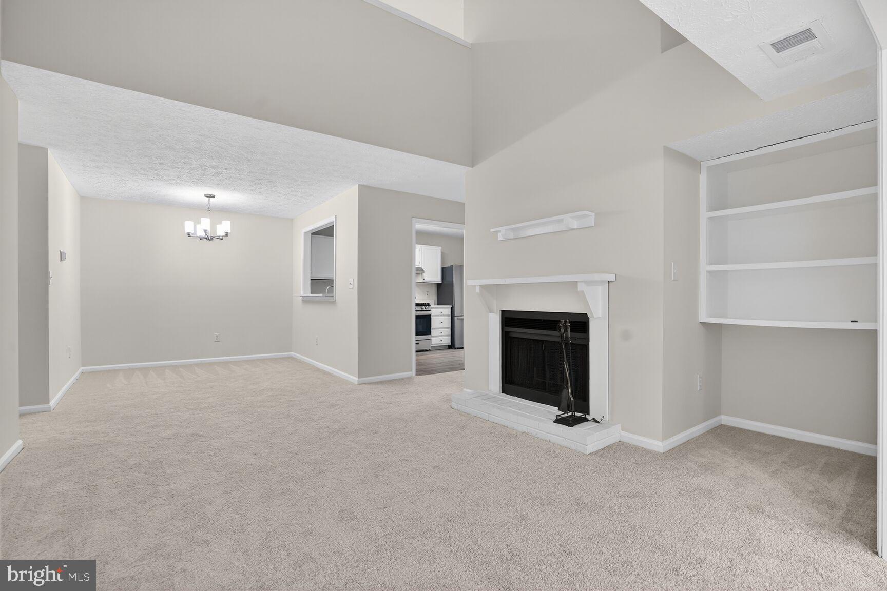 2273 Hunter's Run Drive Reston, VA 20191 - Photo 4 of 23 a view of a livingroom with a fireplace cabinet and window