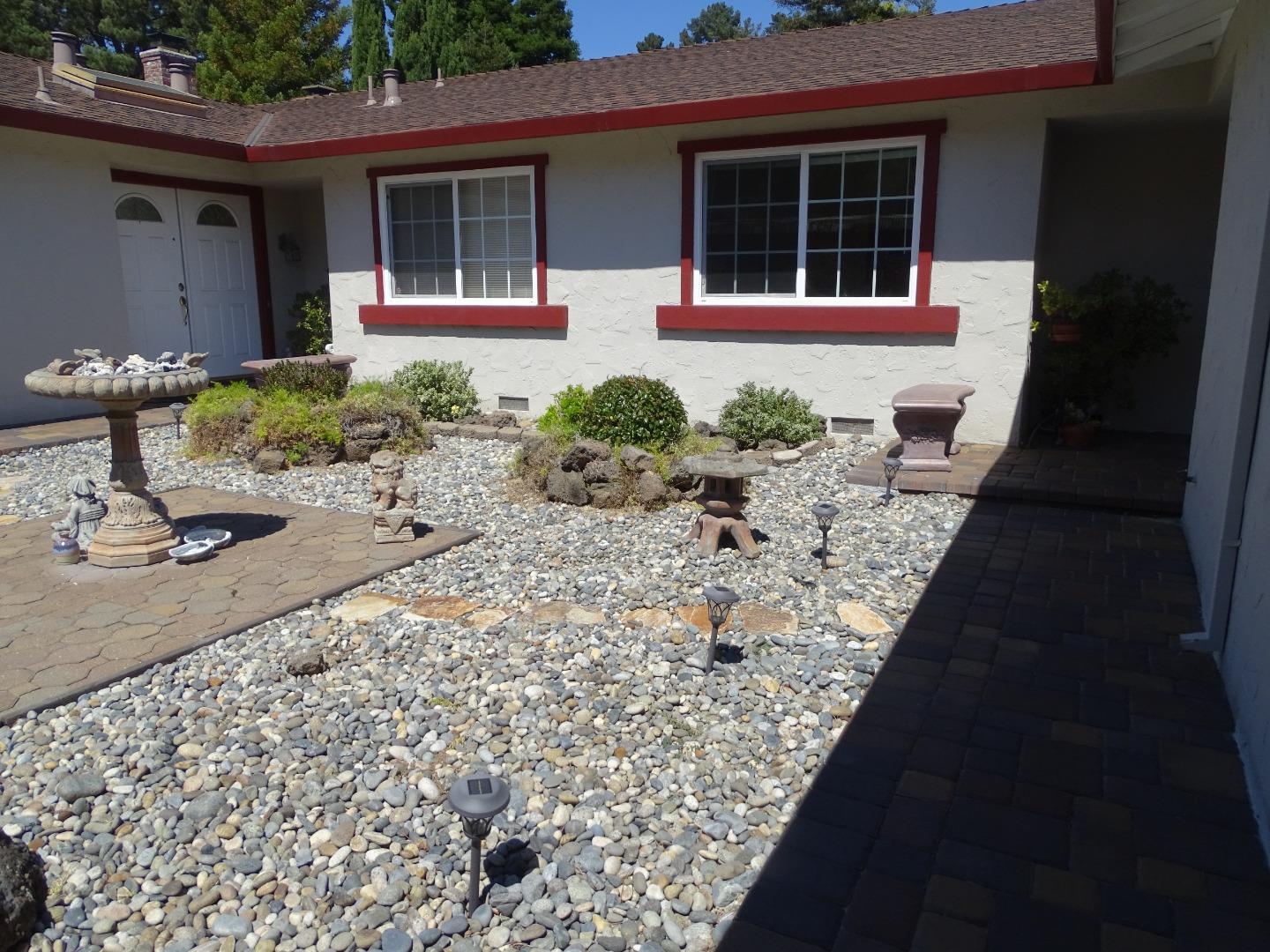a front view of a house with garden