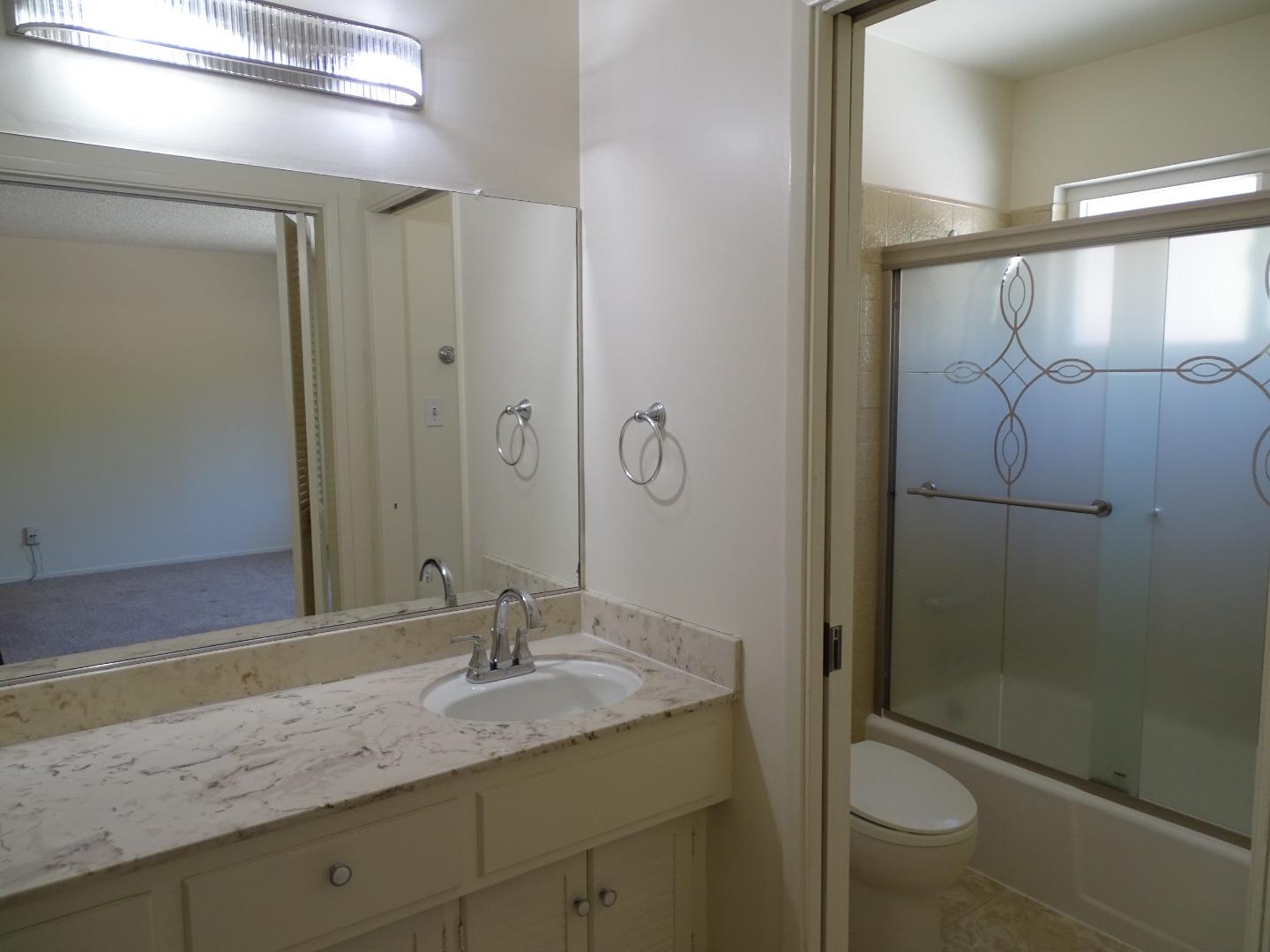 3345 Glendora Drive San Mateo, CA 94403 - Photo 10 of 19 a bathroom with a granite countertop sink toilet and shower