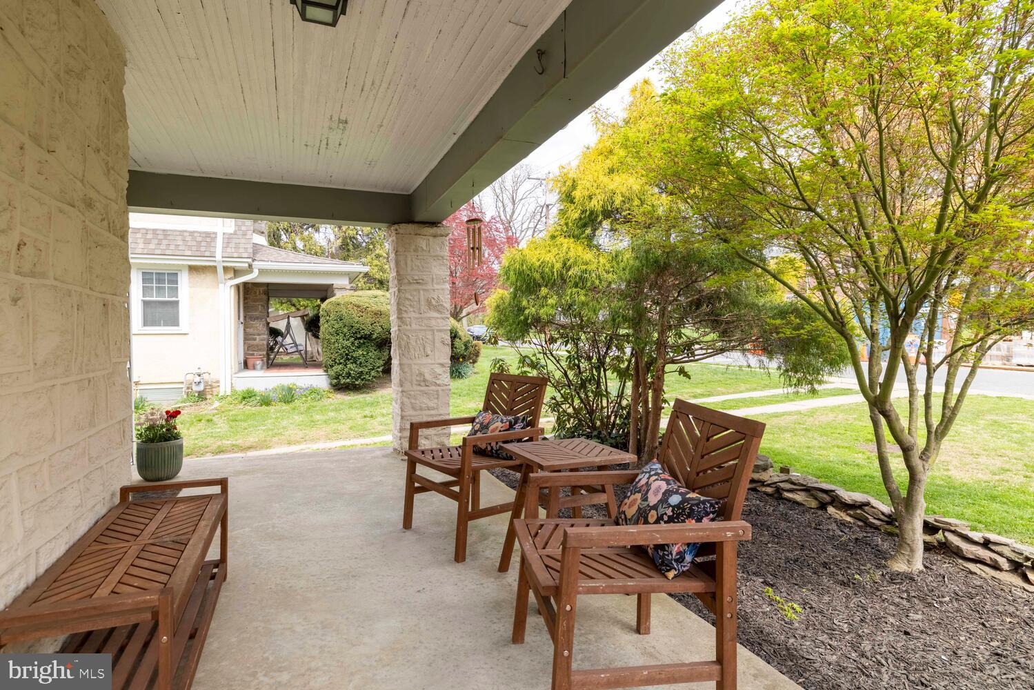 2116 East County Line Road Ardmore, PA 19003 - Photo 5 of 38 a view of a patio with table and chairs and potted plants