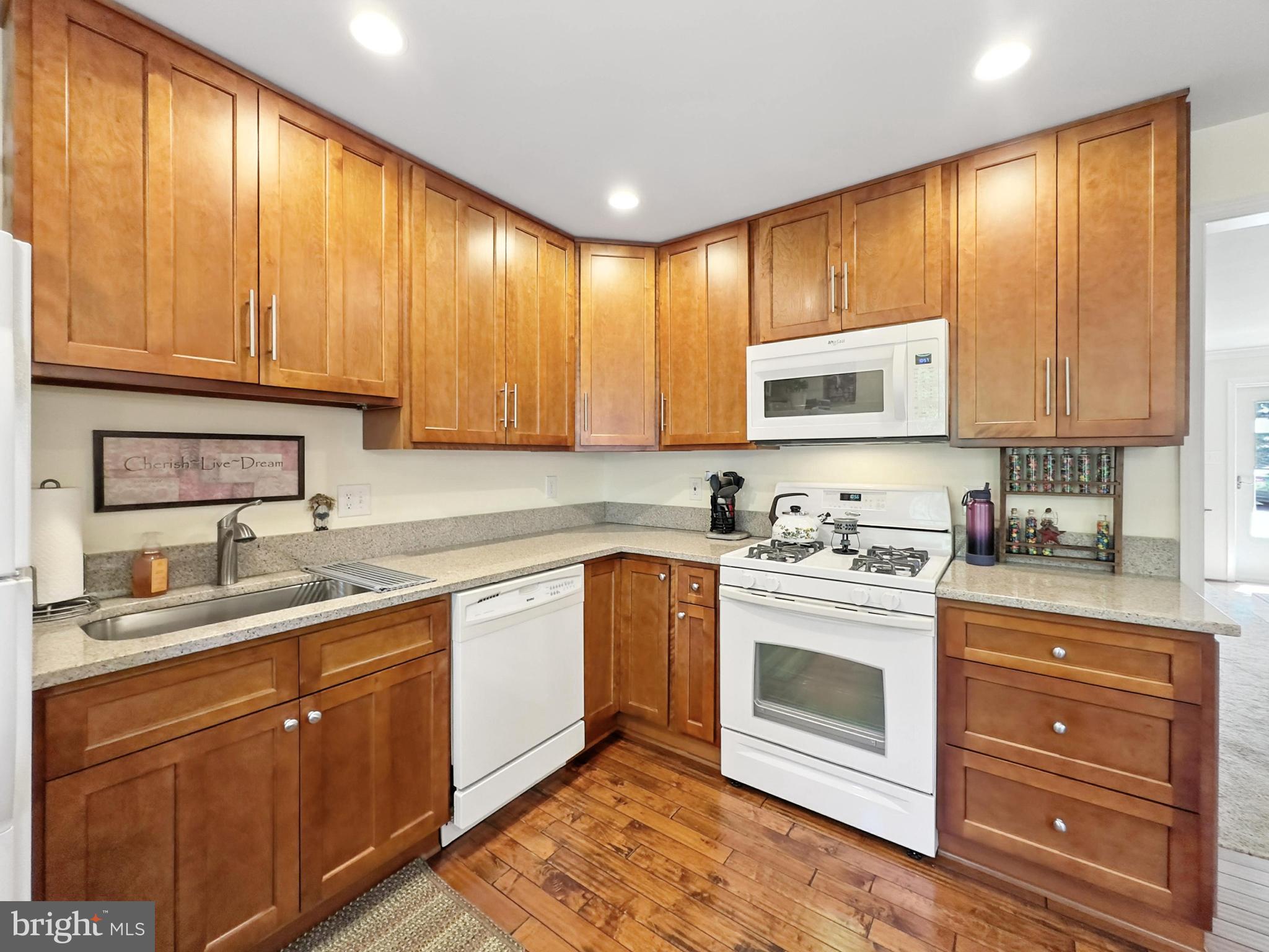 25744 Woodfield Road Damascus, MD 20872 - Photo 16 of 43 Modern kitchen with warm wood cabinetry.