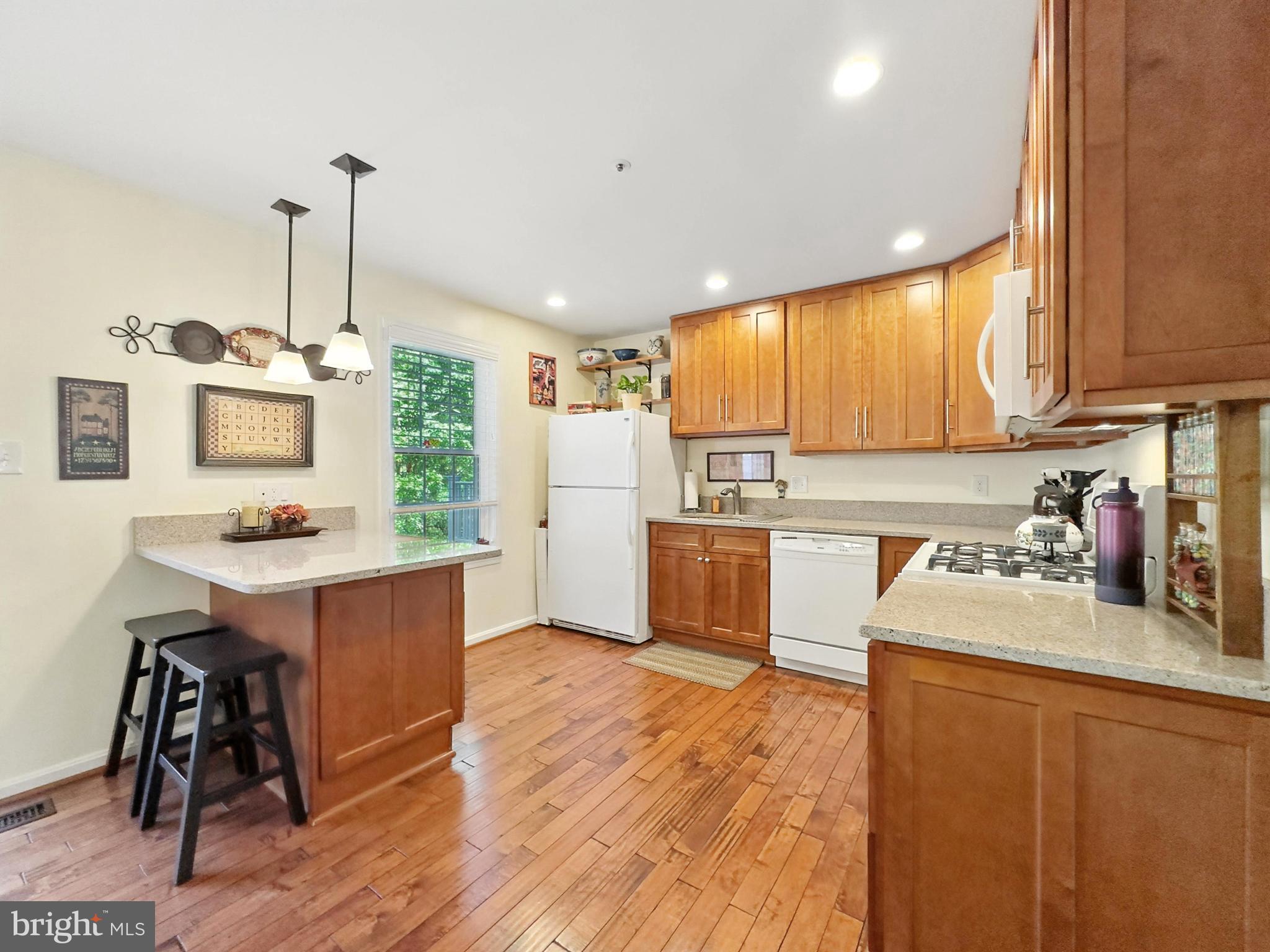 25744 Woodfield Road Damascus, MD 20872 - Photo 17 of 43 Bright and inviting kitchen with warm wood tones.