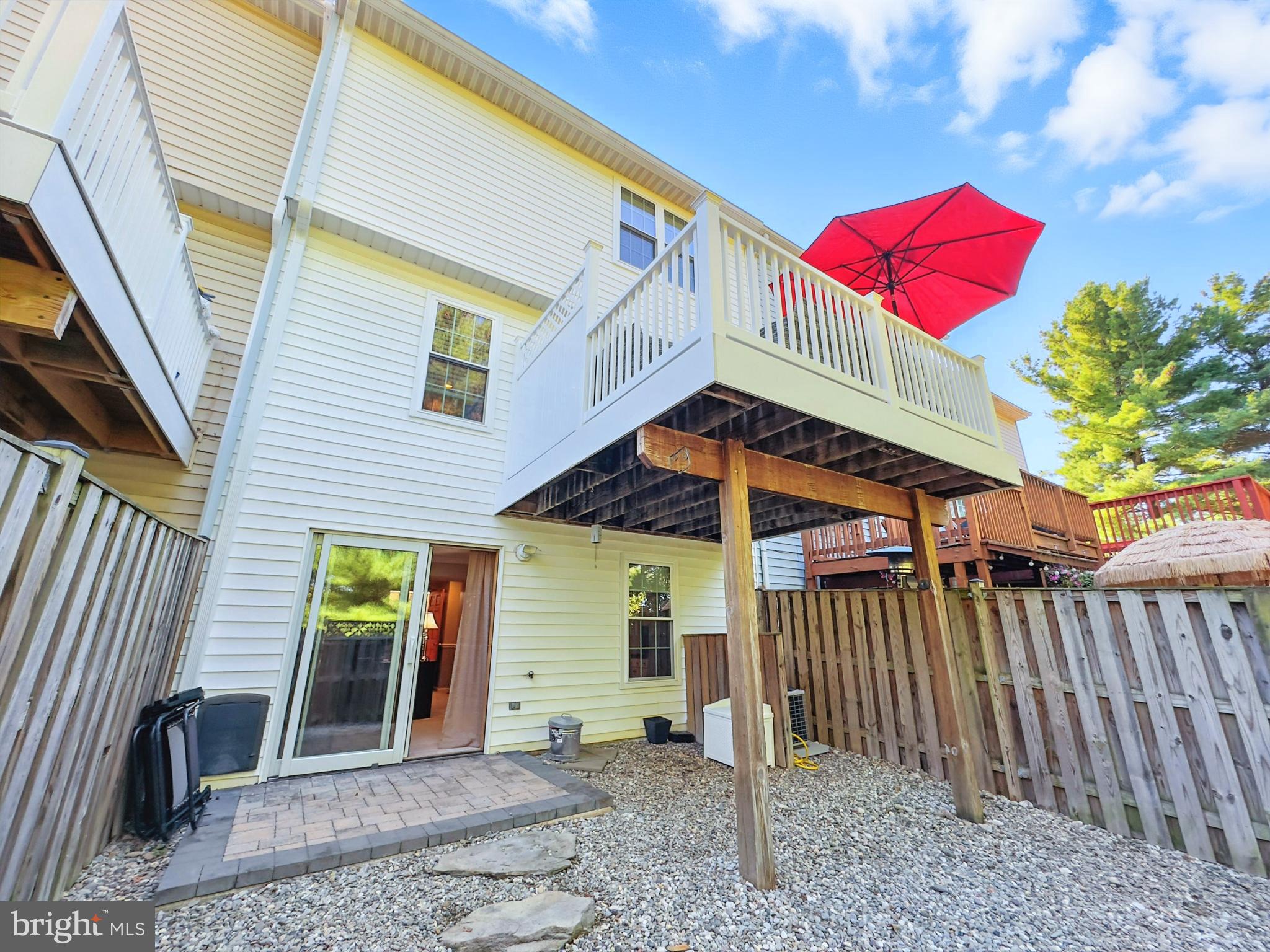 25744 Woodfield Road Damascus, MD 20872 - Photo 39 of 43 Charming backyard retreat with vibrant umbrella.