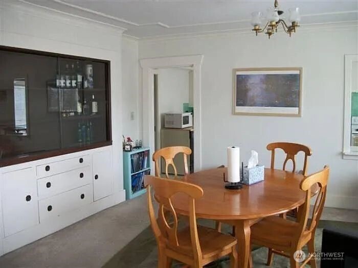 4002 2nd Avenue Northeast Seattle, WA 98105 - Photo 13 of 16 a dining room with furniture and chandelier