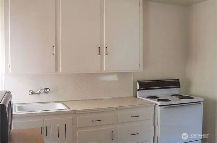 4002 2nd Avenue Northeast Seattle, WA 98105 - Photo 6 of 16 a kitchen with white cabinets and white appliances