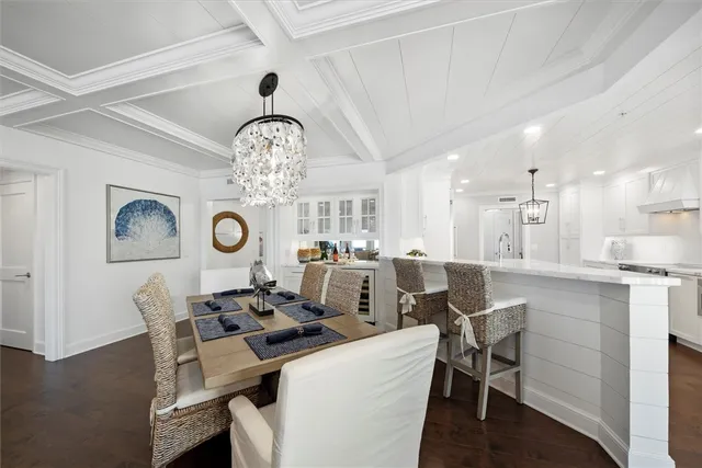 a view of a dining room with furniture and a chandelier