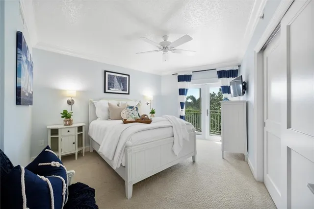 a spacious bedroom with a bed and a chandelier