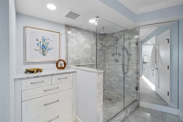a bathroom with a shower sink and mirror