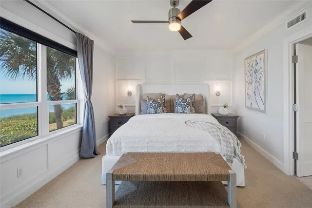 a bed sitting in a spacious bedroom next to a window