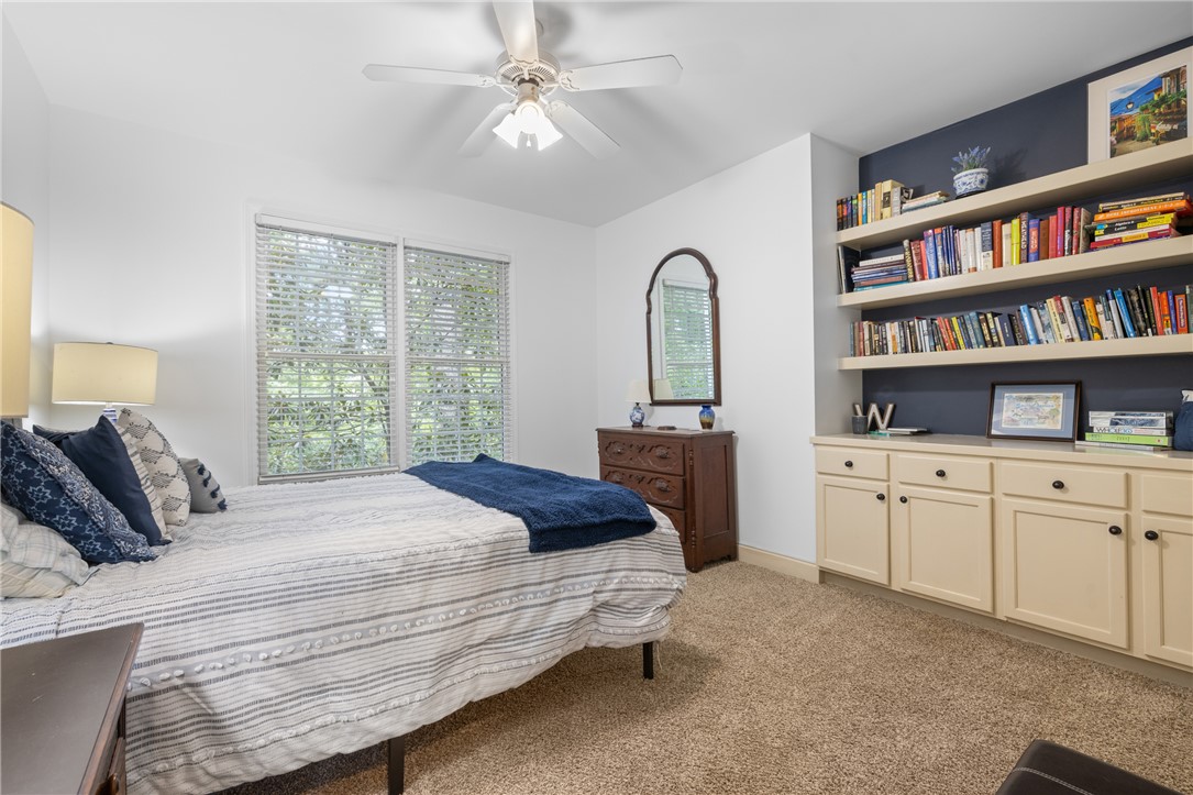 106 Red Maple Way Clemson, SC 29631 - Photo 16 of 49 Plentiful natural light and custom built-in shelving define this comfortable carpeted bedroom.