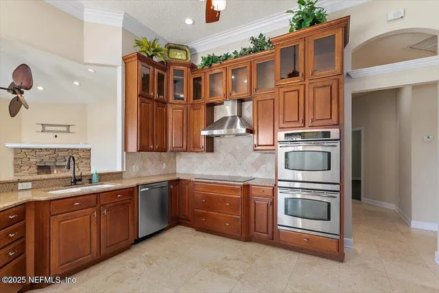 a kitchen with stainless steel appliances granite countertop a refrigerator and cabinets