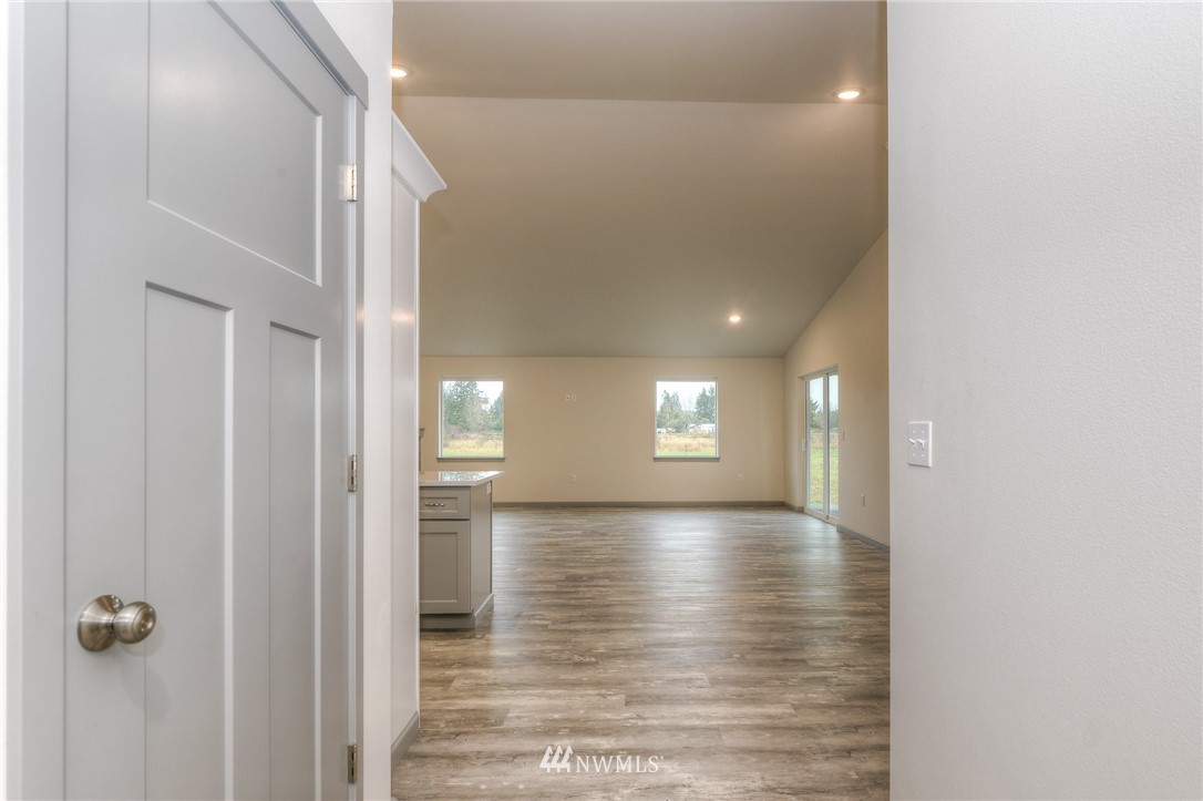 18430 Guava Street Southwest Rochester, WA 98579 - Photo 2 of 36 a view of hallway with window and wooden floor