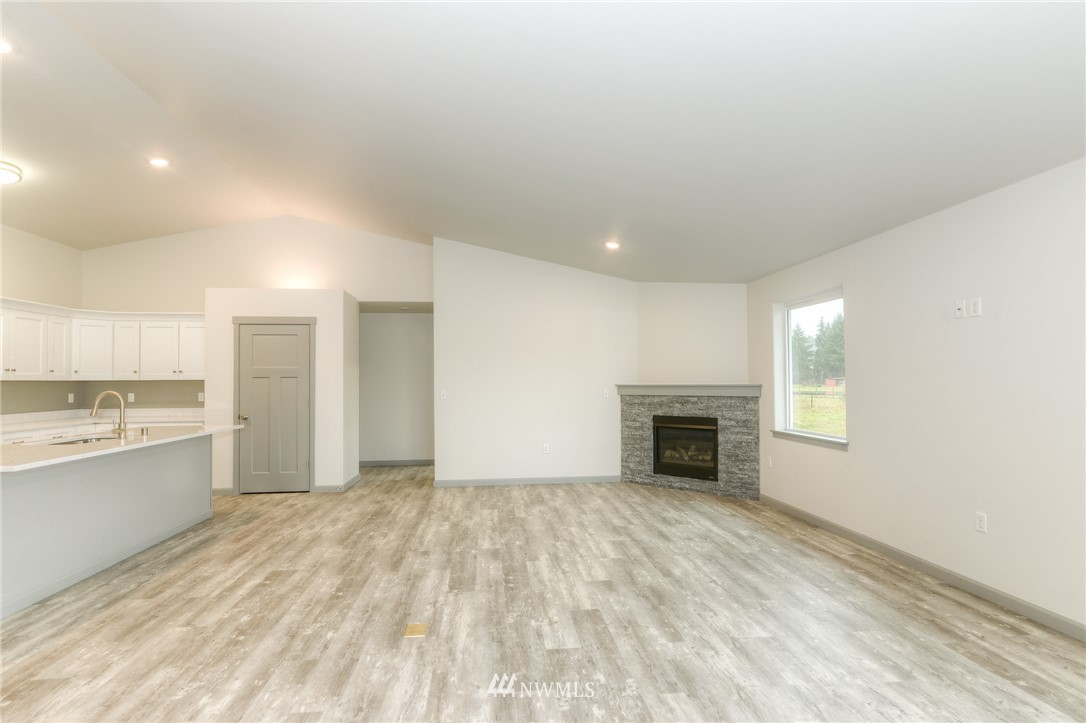 18430 Guava Street Southwest Rochester, WA 98579 - Photo 15 of 36 a view of an empty room with window and fire place