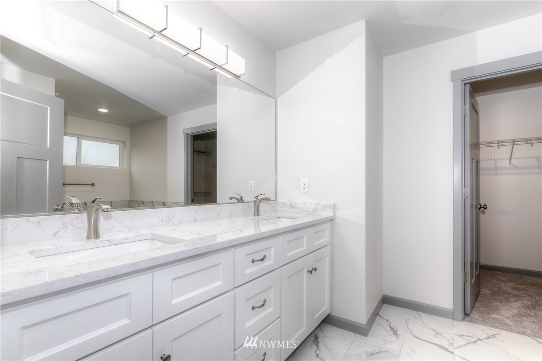 18430 Guava Street Southwest Rochester, WA 98579 - Photo 22 of 36 a bathroom with a granite countertop sink double and mirror