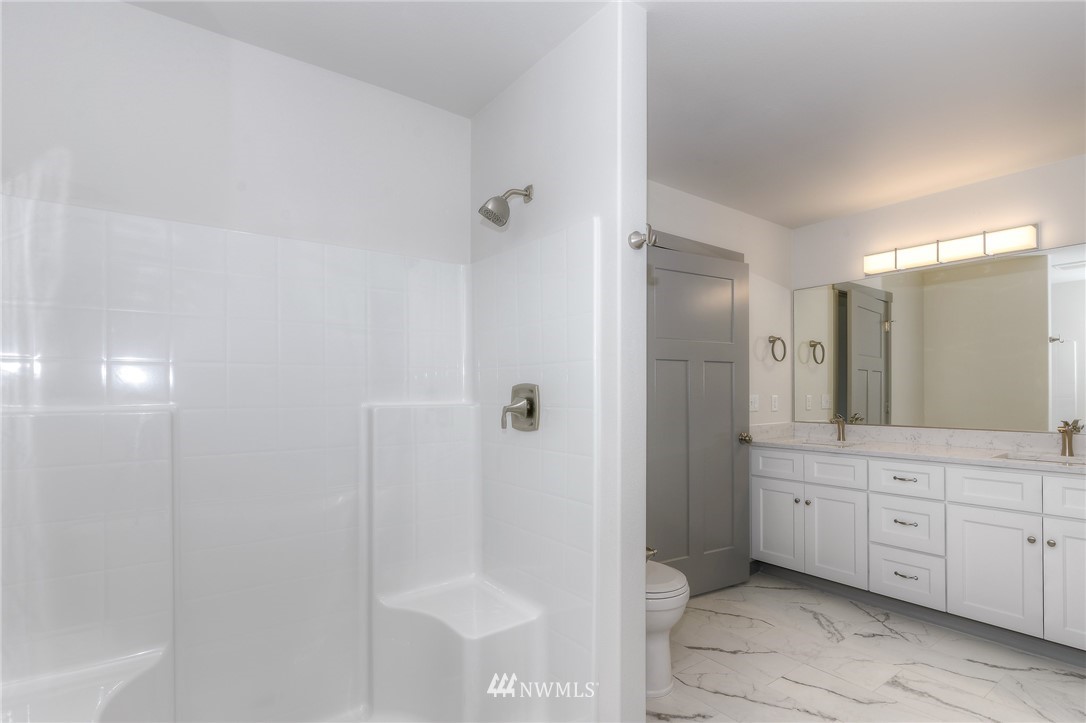 18430 Guava Street Southwest Rochester, WA 98579 - Photo 26 of 36 a spacious bathroom with a shower and a sink