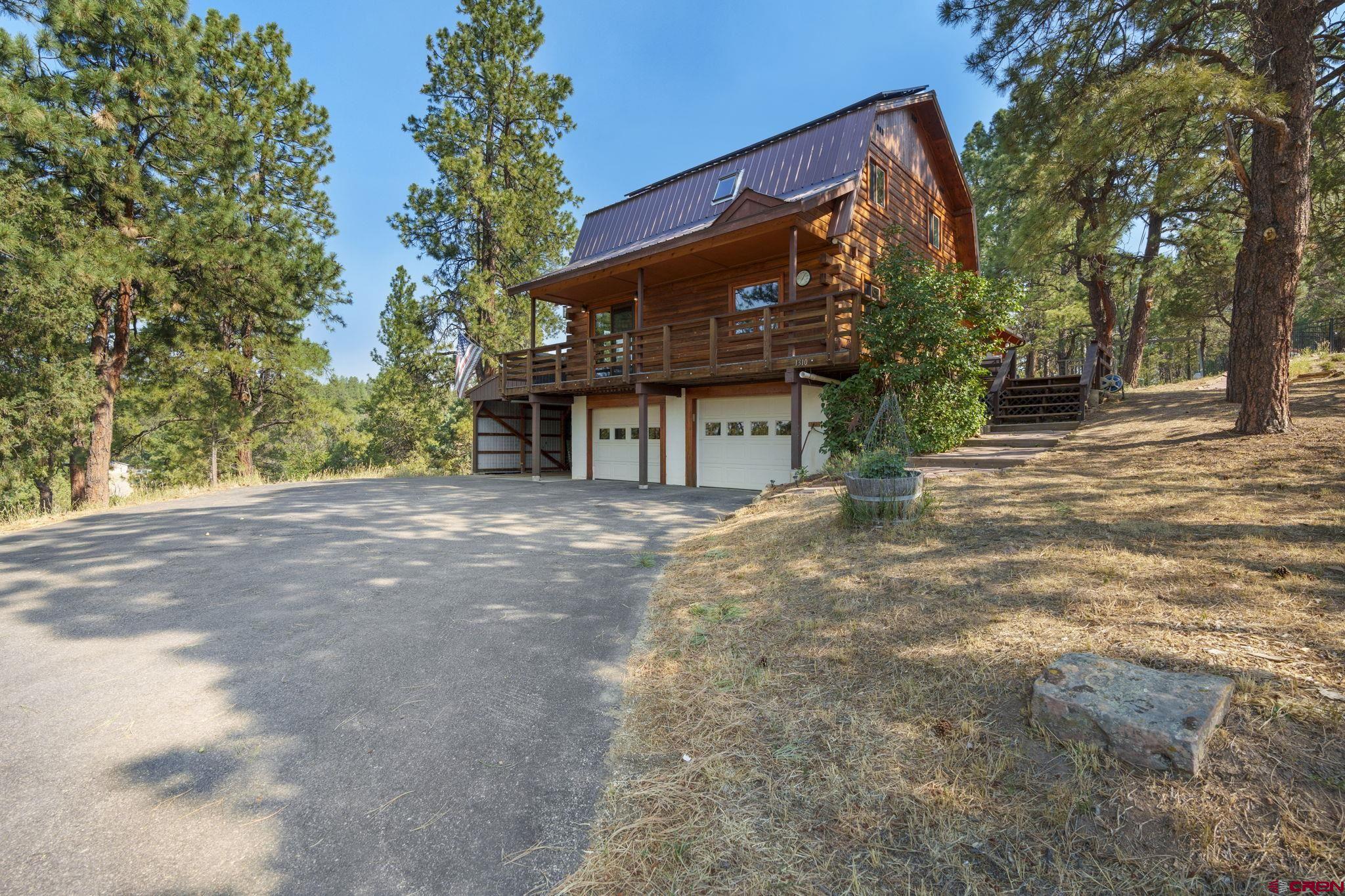 a backyard of a house with large trees and parked