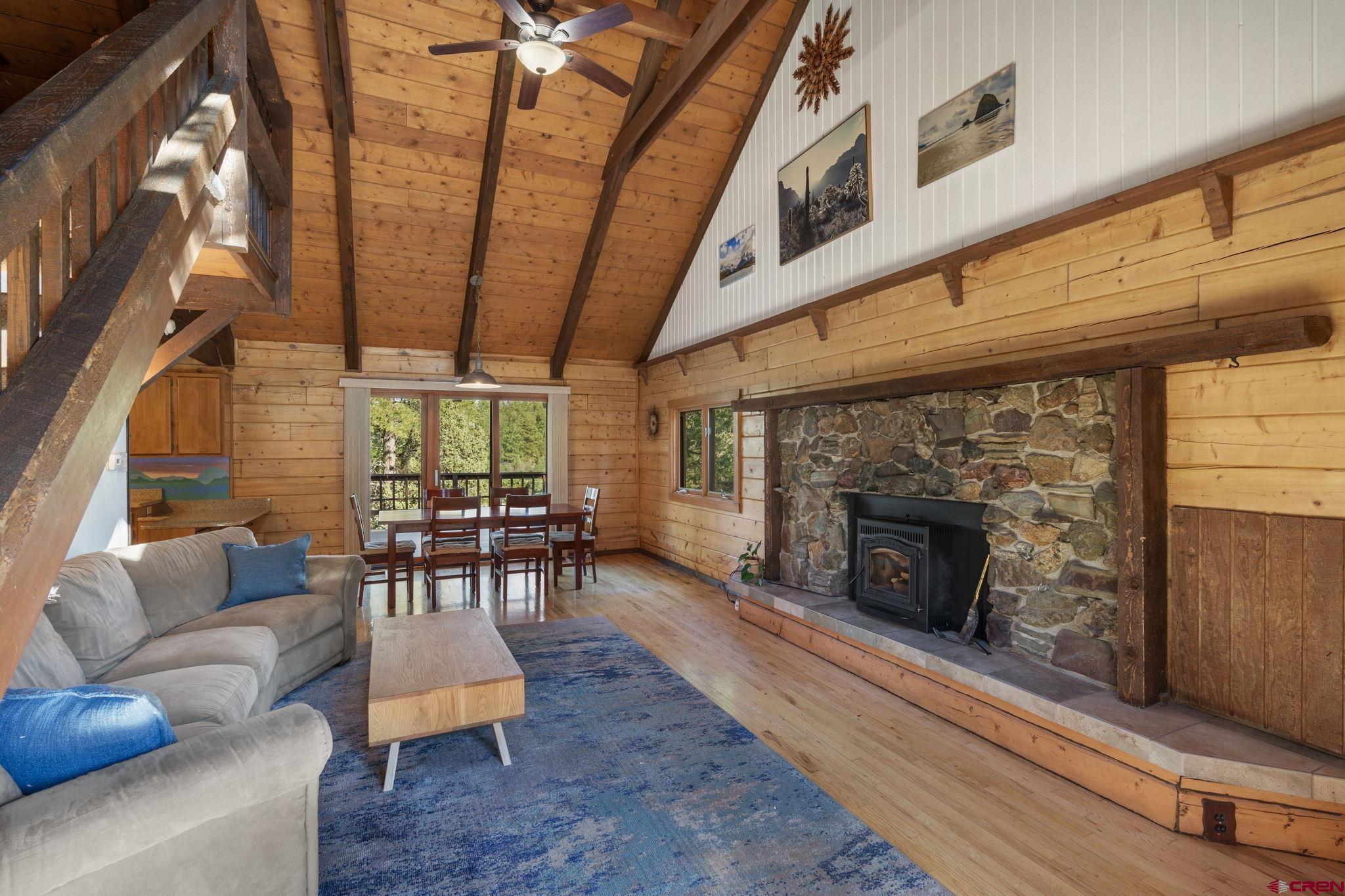 1310 Meadow Road Durango, CO 81303 - Photo 18 of 45 a living room with furniture a fireplace and a table