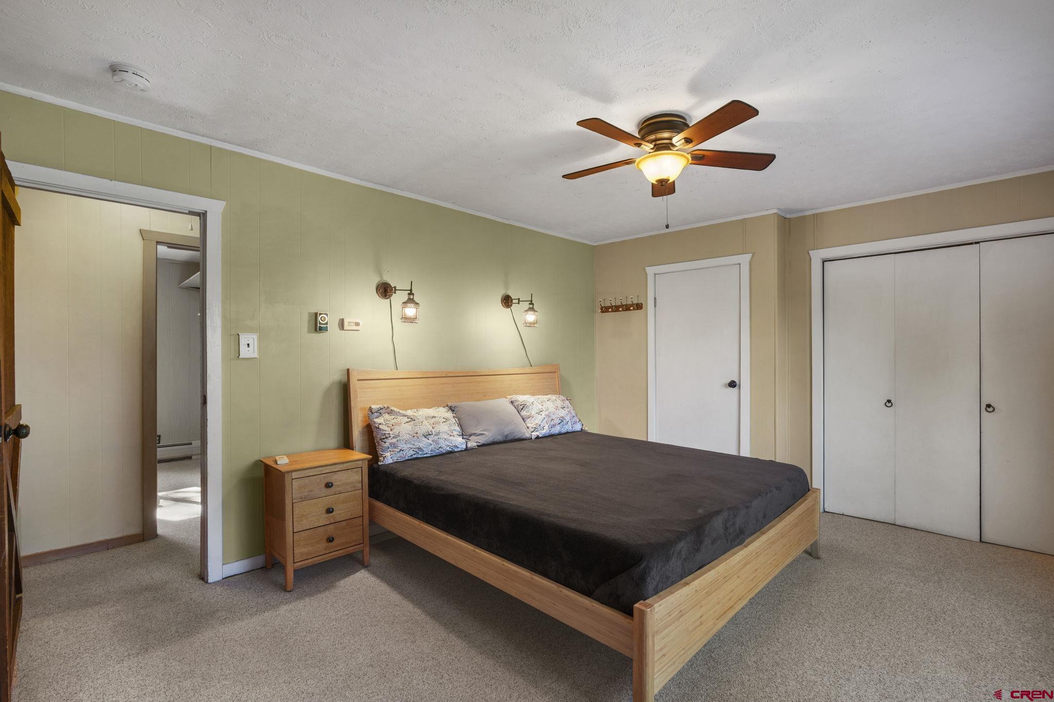 1310 Meadow Road Durango, CO 81303 - Photo 24 of 45 a bedroom with a bed and a chandelier fan
