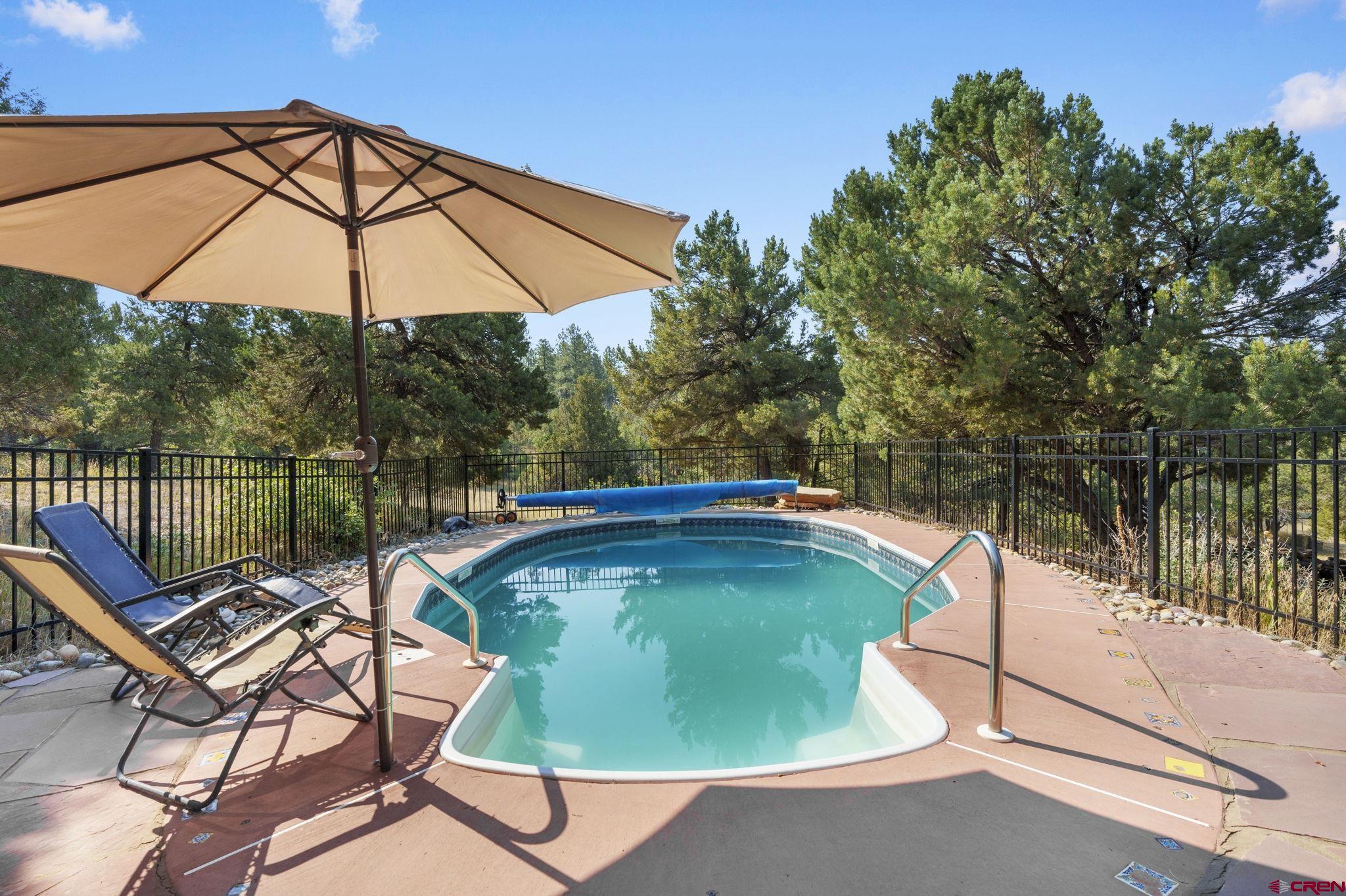 1310 Meadow Road Durango, CO 81303 - Photo 35 of 45 a view of a swimming pool with a lounge chair