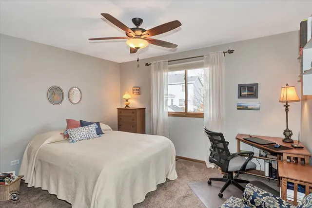 a bedroom with a bed and a desk