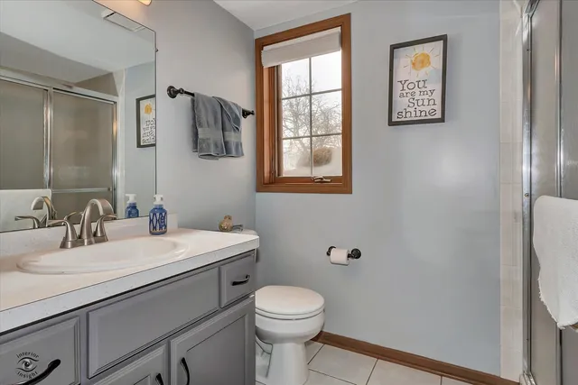 a bathroom with a sink a toilet and mirror